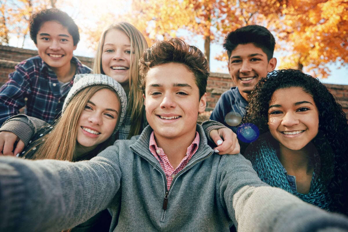 Friends, teenager and group selfie in the park, nature or fall trees and teens smile, picture of friendship and happiness for social media. Portrait, face and happy people together for autumn photo.